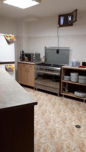 a kitchen with a stove and a counter top at Guest House Zarkova Kushta in Zheravna