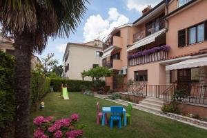a yard with colorful furniture in front of a building at Apartments Alice in Rovinj
