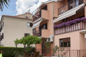 un edificio de apartamentos con flores en los balcones en Apartments Alice, en Rovinj