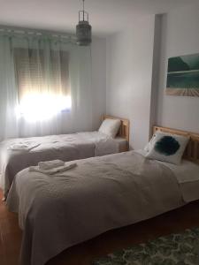 Łóżko lub łóżka w pokoju w obiekcie Casa Lina Belavista