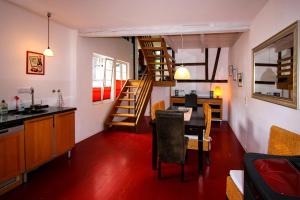 cocina y sala de estar con mesa y escalera en Ferienhaus Atelier, en Enkirch