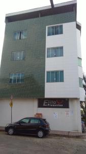 a black car parked in front of a building at Pousada Elita in Divinópolis