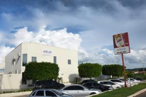 a building with cars parked in a parking lot at Ello Hotel in Iguatu