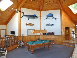 a pool table in a room with fish on the wall at Brown's Bay Resort in Heriot Bay