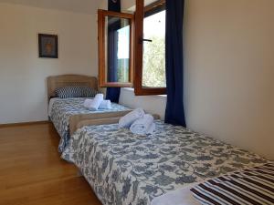 a room with two beds with towels on them at Holiday Home Strpuncina in Luka