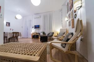 a living room with a couch and chairs in it at Pijama Hostel in Plovdiv