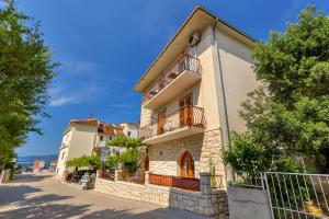 a building with balconies on the side of a street at Apartment Kate in Podgora