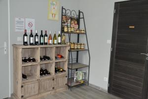 a shelf with bottles of wine in a room at Domaine de Biscaye in Lourdes