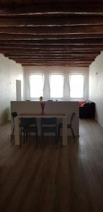 a room with a table and two chairs and two windows at Ca' dell'Angelo in Chioggia +51 photos