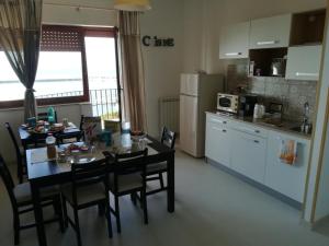 a kitchen with a table and chairs and a kitchen with a table and a kitchen at Guest House Domus Cicerone in Formia