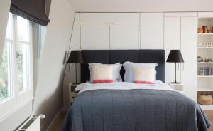 a bedroom with a large bed with a black headboard at BB Museumquarter in Amsterdam