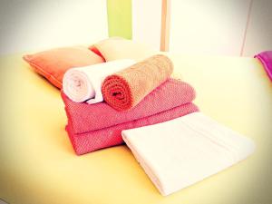 a pile of towels sitting on top of a table at Residencia Praia Norte - AL in Nazaré +112 photos