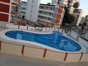 a large swimming pool on the side of a building at Junto al mar in Torre del Mar