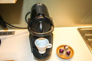 a coffee cup sitting on top of a coffee maker at Dynasta Central Suites in Athens