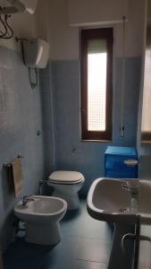 Baño azul con aseo y lavamanos en Casa Michelina, en Belvedere Marittimo