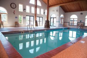 an indoor swimming pool with a clock on the wall at Black Hills Luxury Suites in Hill City