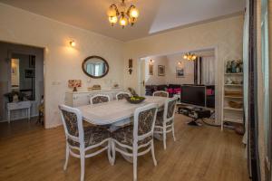 a dining room with a white table and chairs at Apartment Valerija in Jesenice