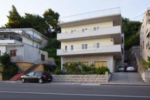 a building with a car parked in front of it at Apartment Valerija in Jesenice