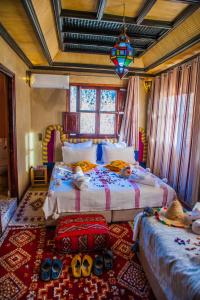a bedroom with two beds with shoes on the floor at Toubkal Ecolodge in Imlil