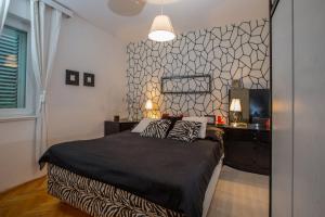 a bedroom with a bed with two pillows on it at Apartment Valerija in Jesenice