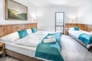 two beds in a room with blue and white at Dworek Nad Białką in Czarna Góra