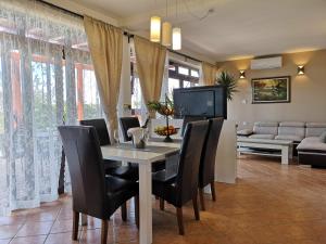 a dining room with a table and black chairs at Meerblick Ferienhaus Julian nahe Rovinj in Rovinj