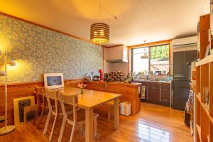 a kitchen with a wooden table and a dining room at Share Creative&Bed adonoan in Takeo +46 photos