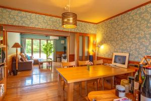 a living room with a table and a couch at 星に抱かれる宿アドノアン Share Creative&Bed adonoan in Takeo