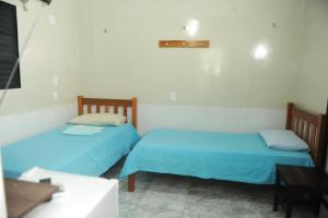 Un pat sau paturi într-o cameră la Hotel Bem Vindo