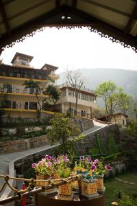a group of potted plants in front of a building at Veda5 Ayurveda & Yoga Retreat in Rishīkesh