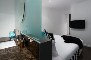 a hotel room with a bed and a mirror at QT Falls Creek in Falls Creek
