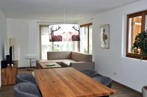 a living room with a table and a couch at Crastuoglia 855-1 in Scuol