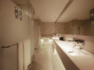 a bathroom with two sinks and a large mirror at Resorts World Genting - Genting SkyWorlds Hotel in Genting Highlands