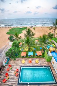 an overhead view of a swimming pool and the beach at Hotel J Negombo in Negombo