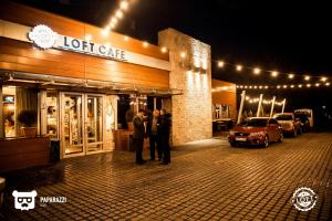 a group of people standing outside of a store at night at Academic Apartments in Almaty
