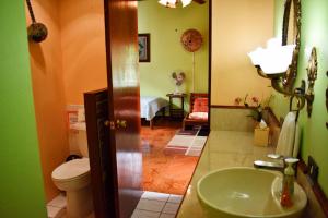 a bathroom with a sink and a toilet at Cariari Bed & Breakfast in San José +42 photos