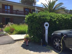 a parking meter next to a car in front of a house at Arli Hotel Hideaway Punta Ala - Adults Only in Punta Ala