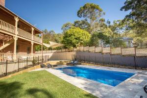 a swimming pool in the backyard of a house at Palmyra B&B in Rainbow Flat