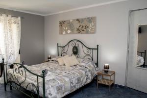 a bedroom with a bed with a black frame at B&B Villa San Nicola in San Nicola Arcella