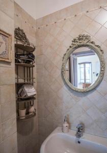 a bathroom with a sink and a mirror at Il Prunaio in Corsanico-Bargecchia