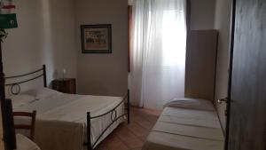 A bed or beds in a room at Casa di Alfredo Affittacamere