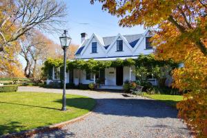 a white house with a street light in front of it at Marlborough B & B in Tuamarina