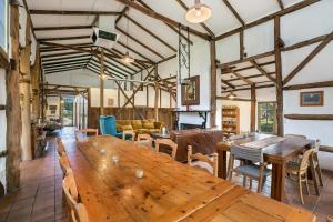 a large room with a wooden table and chairs at Taradale House Estate in Taradale