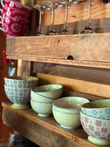 a group of bowls on a wooden shelf at Campo Portakal Eco Glamping in Cıralı