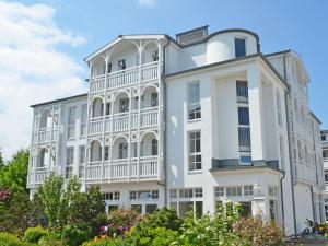 a large white building with a white balcony at Seepark Sellin - Apt. 382 in Ostseebad Sellin