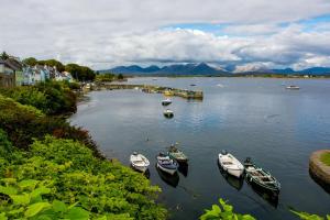 a group of boats docked in a body of water at Cottage 236 Roundstone in Roundstone