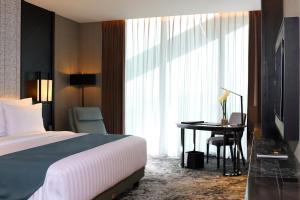 Letto o letti in una camera di JHL Solitaire Gading Serpong