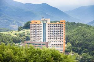 a large building in the middle of a mountain at Jiri Mountain Ilsung Condo in Namwon