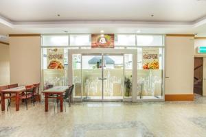 a fast food restaurant with tables and chairs in a room at Jiri Mountain Ilsung Condo in Namwon