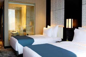 Letto o letti in una camera di JHL Solitaire Gading Serpong